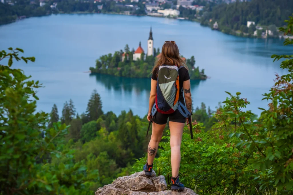 A young woman standing on the top of Osojnica Hill above lake Bled