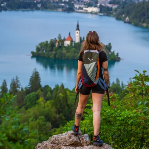 A young woman standing on the top of Osojnica Hill above lake Bled