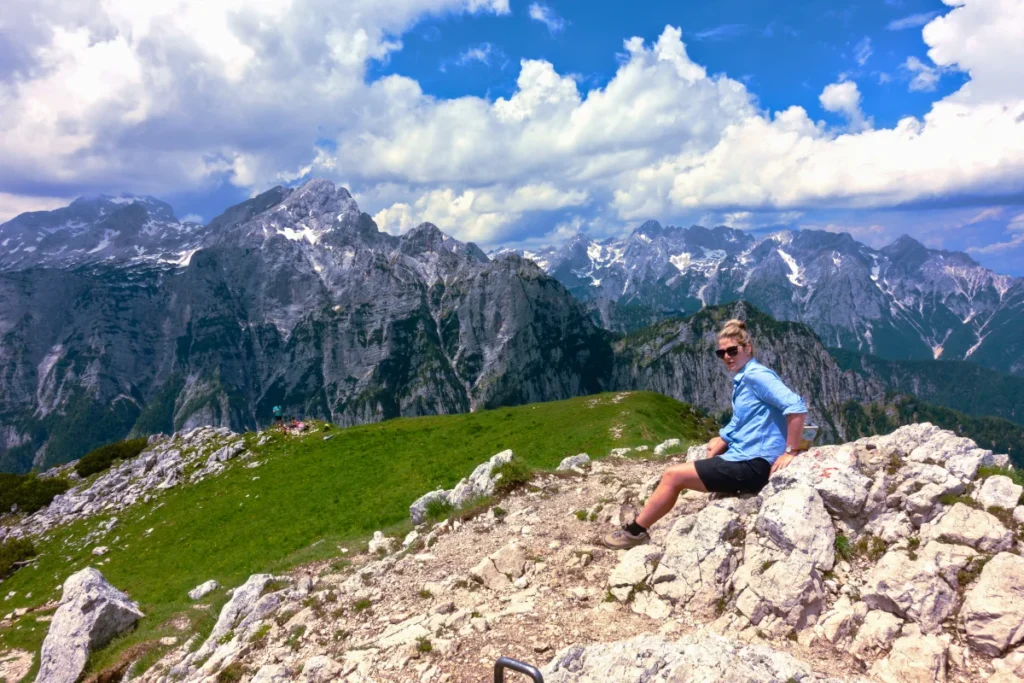 A young woman enjoying the view of the Julian Alps on mt. Debela Pec