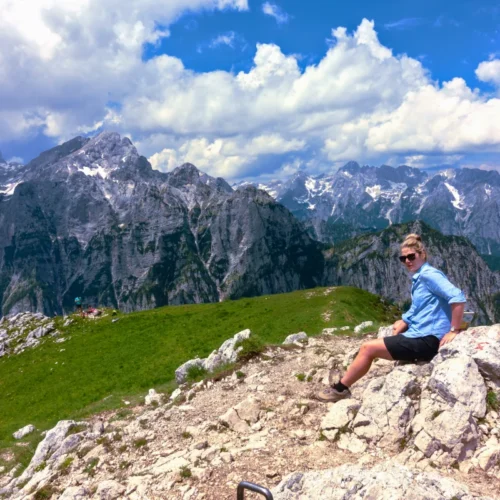A young woman enjoying the view of the Julian Alps on mt. Debela Pec