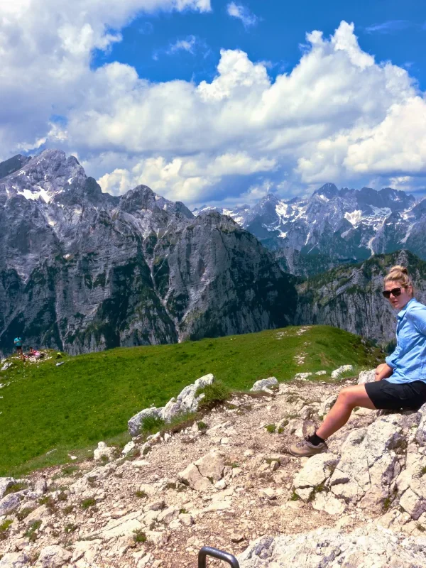 A young woman enjoying the view of the Julian Alps on mt. Debela Pec