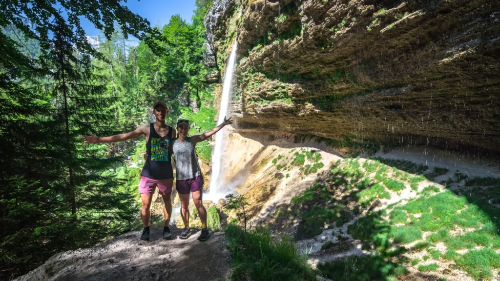 A couple standing in front of Pericnik Waterfall