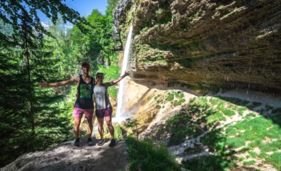 A couple standing in front of Pericnik Waterfall