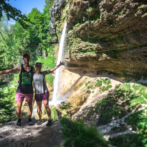 A couple standing in front of Pericnik Waterfall