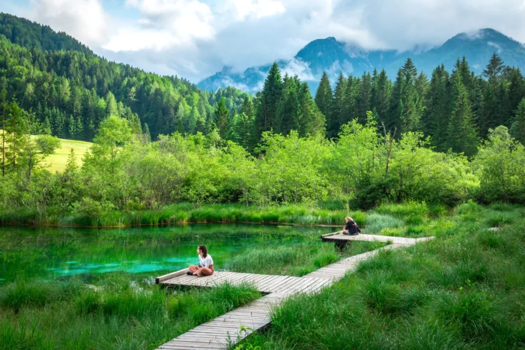 A girl sitting next to Zelenci Springs