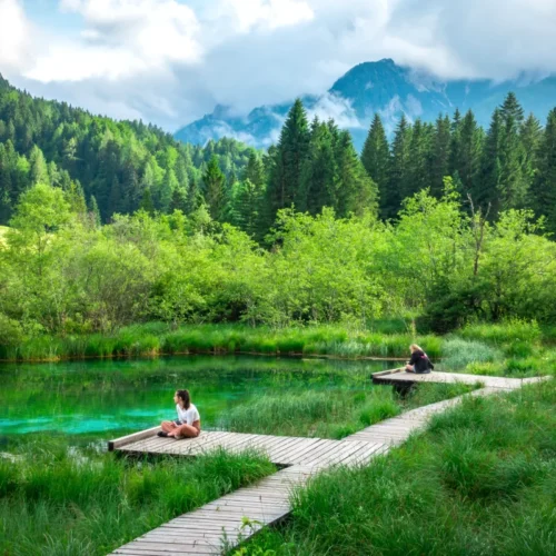 A girl sitting next to Zelenci Springs